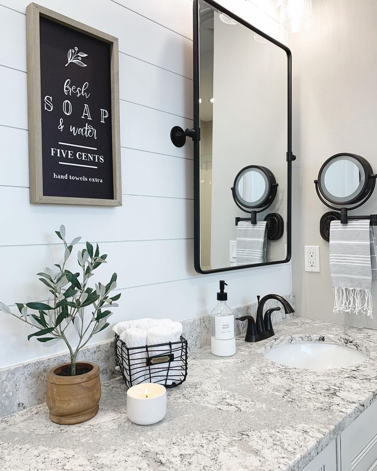 a bathroom with two sinks and a large mirror on the wall above it's counter