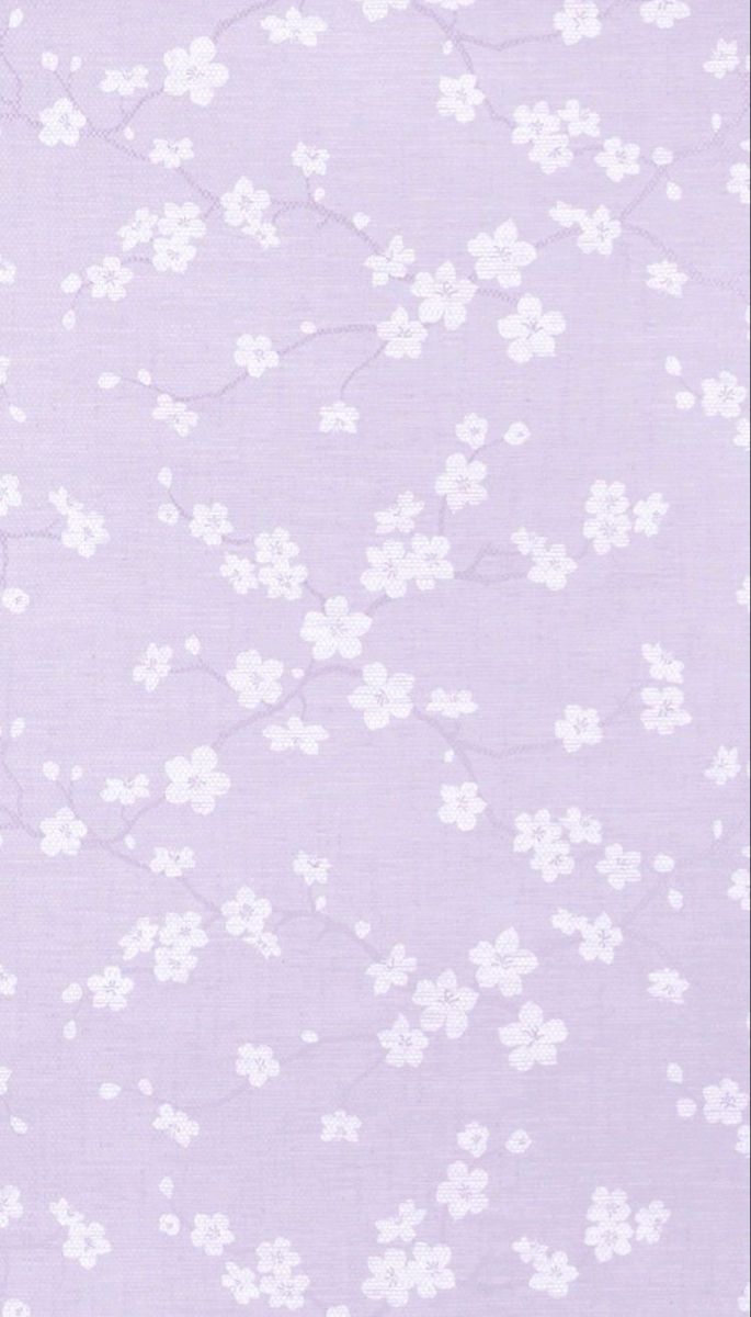 a purple background with small white flowers on the top and bottom part of the fabric