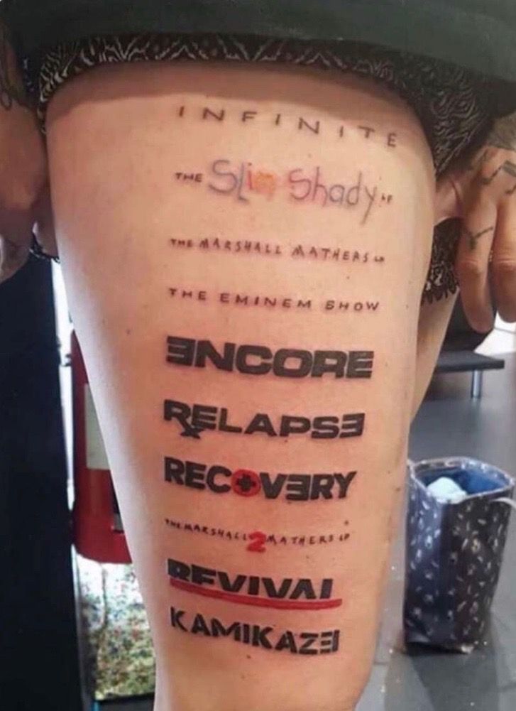 the back of a person's leg with tattoos on it and words written in different languages