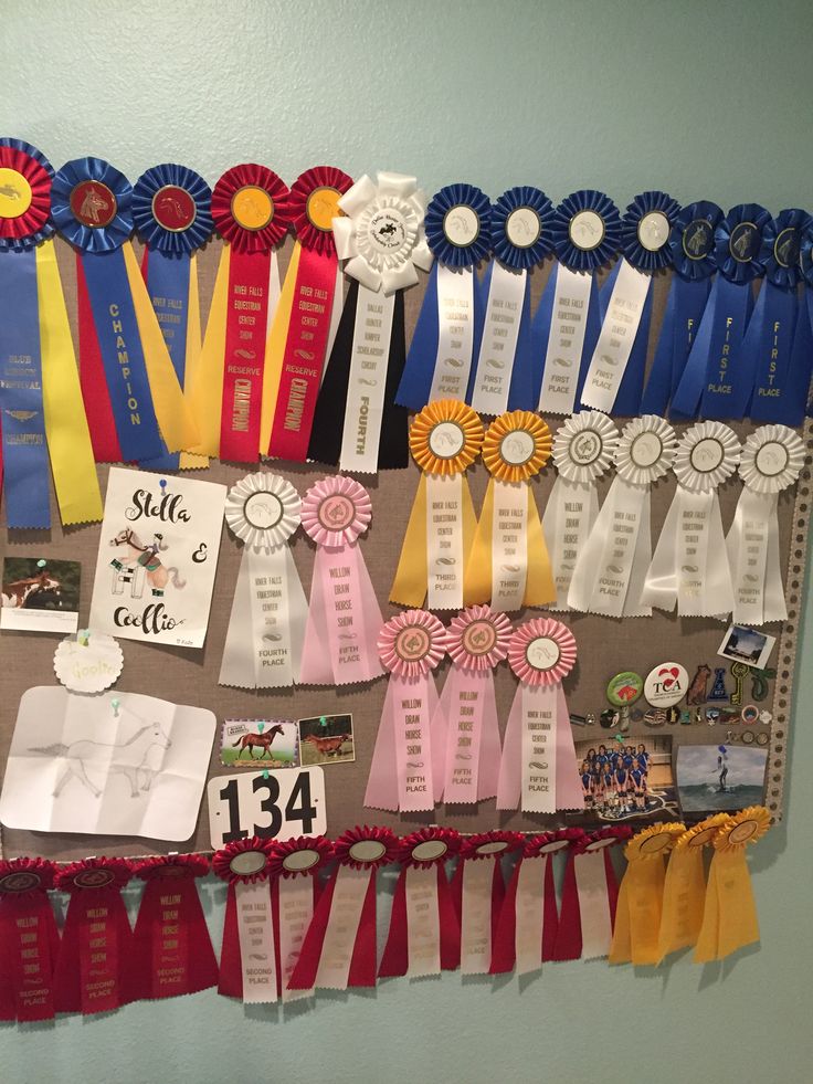 a bulletin board with ribbons and medals on it