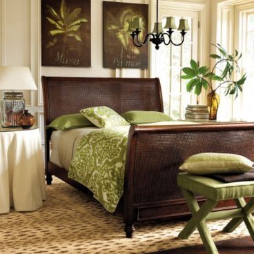 a bed room with a neatly made bed next to a chair and table in front of a window