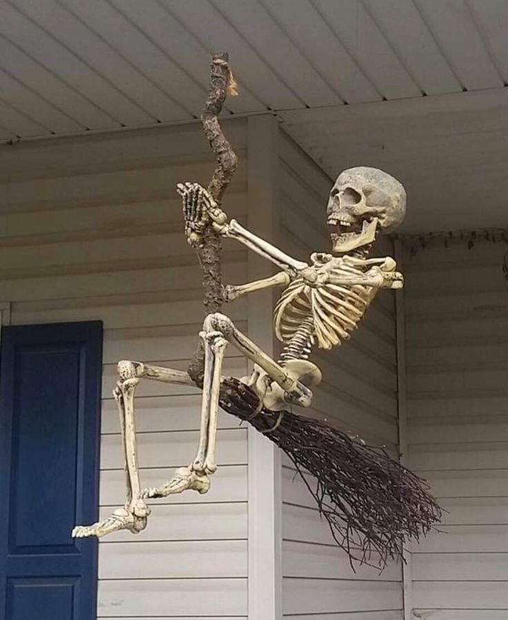 a skeleton with a broom is in the air