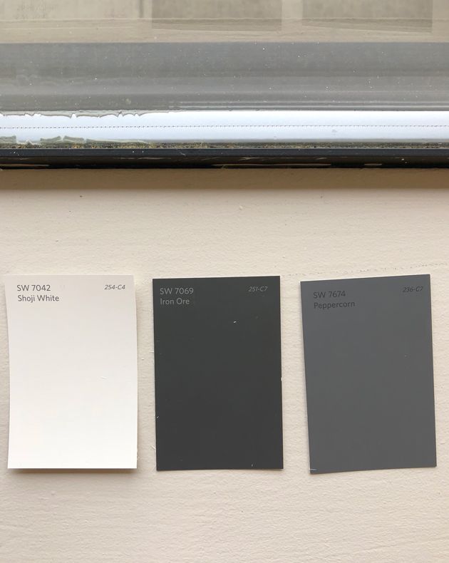 three different shades of gray and white paint on a wall with a window in the background