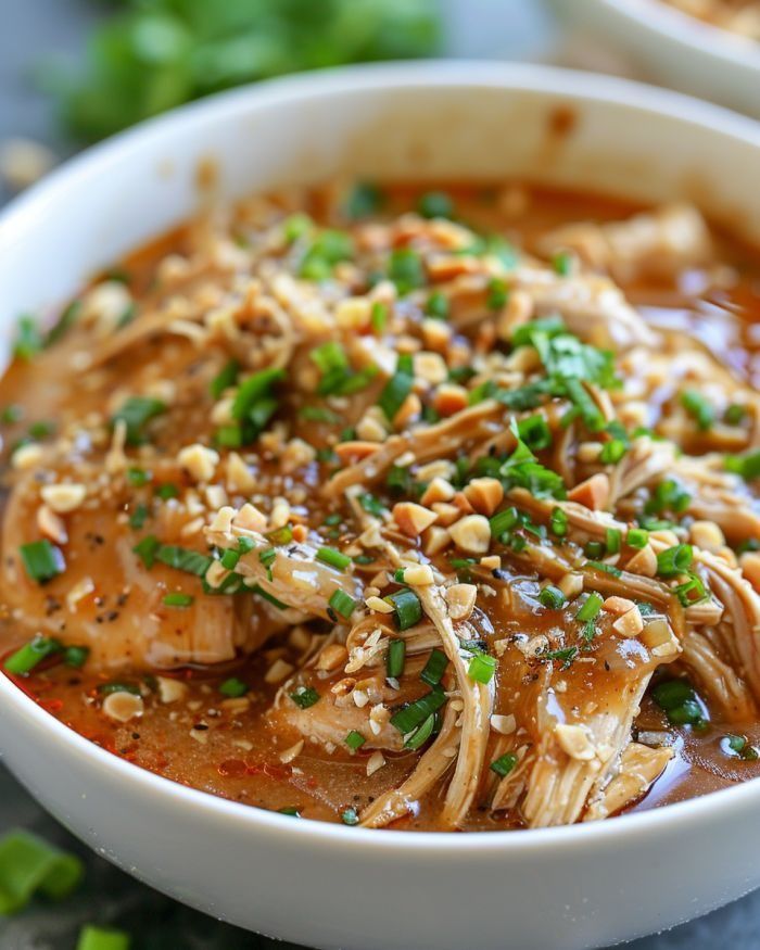 a white bowl filled with meat and vegetables