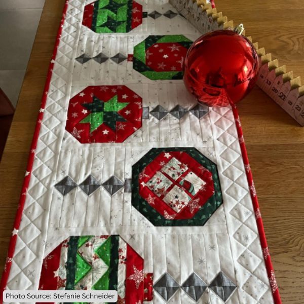 a table runner with red and green ornaments on it