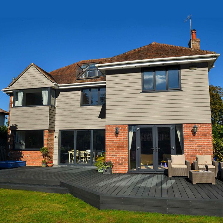 a large house with an attached deck and patio