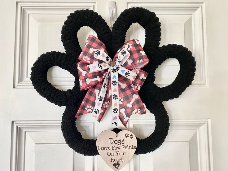 a mickey mouse door hanger with a dog's paw and heart on it