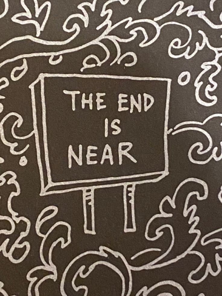 the end is near written in white chalk on a black background with decorative swirls