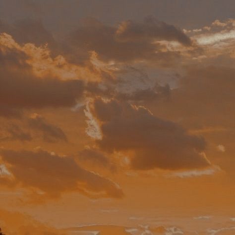 an airplane is flying in the sky at sunset or dawn with some clouds above it