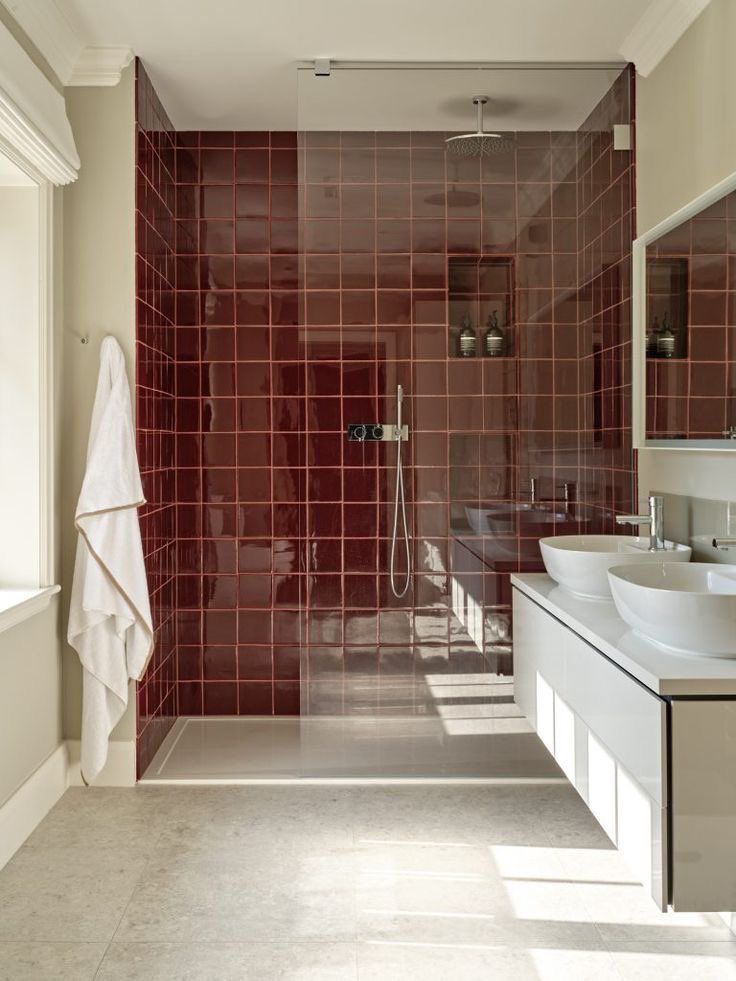 a bathroom with two sinks and a shower