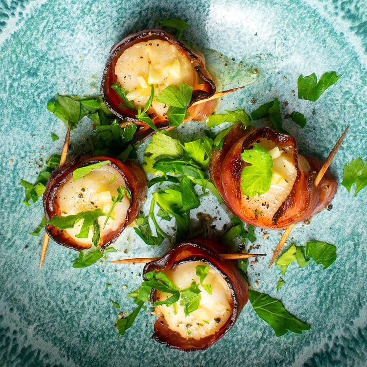 small appetizers are arranged on a blue plate