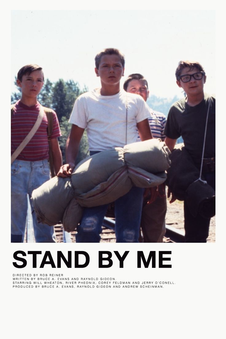 a group of young men standing next to each other with luggage on their backs and the words stand by me above them