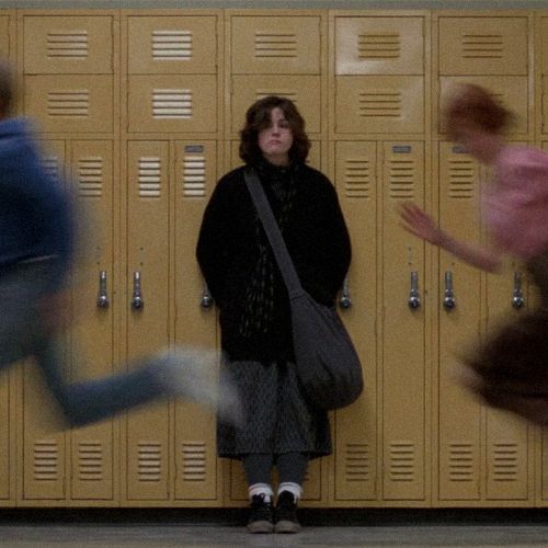 two people standing in front of lockers with their hands out and one person jumping