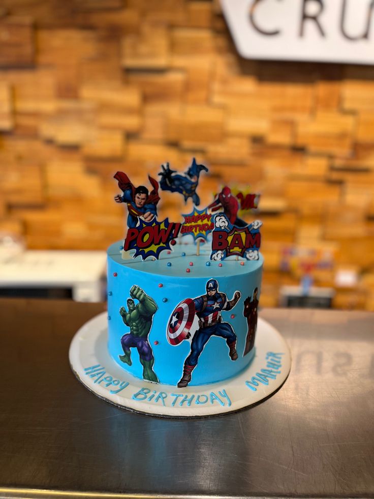 a birthday cake with captain america decorations on it