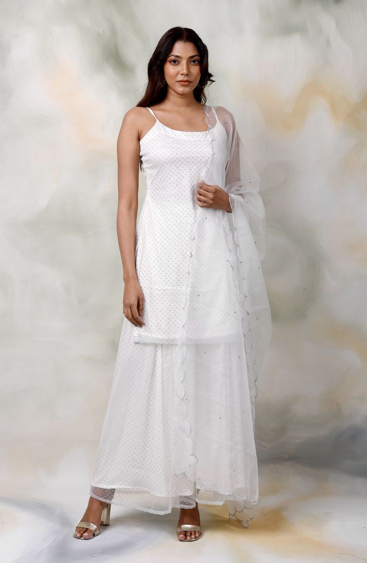 Amp up your look with the grace and simplicity of this new white sharara suit with overall embroidery. Having a lightweight dupatta and an easy-to-style appeal, this lehnga is an excellent pick for days when you are looking for sheer perfection.StyleWhite Sharara Suit Embroidered DetailingMatching DupattaOrganza DupattaModel height - 5'7"Model wearing - S White Palazzo Set With Sheer Dupatta And Straight Kurta, White Floor-length Palazzo Set With Chikankari Embroidery, Anarkali Style White Floor-length Palazzo Set, White Anarkali Floor-length Palazzo Set, White Georgette Floor-length Anarkali Set, Traditional White Floor-length Palazzo Set, White Anarkali Set With Resham Embroidery In Maxi Length, White Anarkali Set With Sheer Dupatta For Diwali, White Palazzo Set With Sheer Dupatta For Diwali