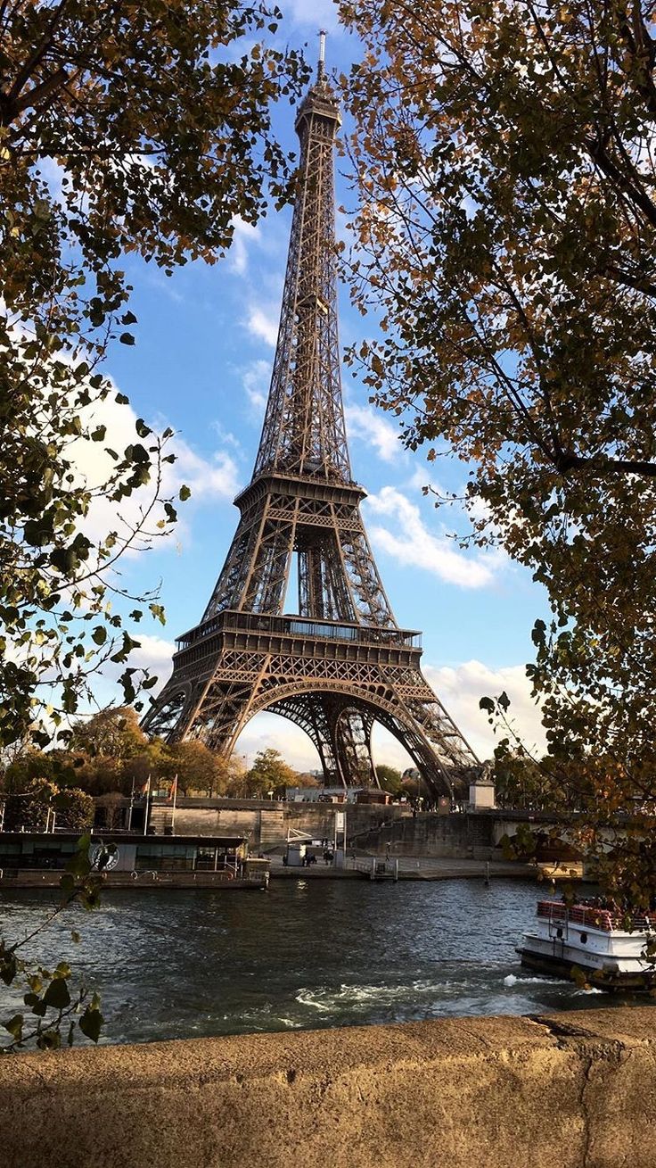 the eiffel tower towering over the river seine in paris, france on a sunny day