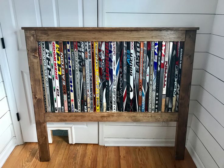 a wooden headboard made out of skis and snowboards in a room with white walls