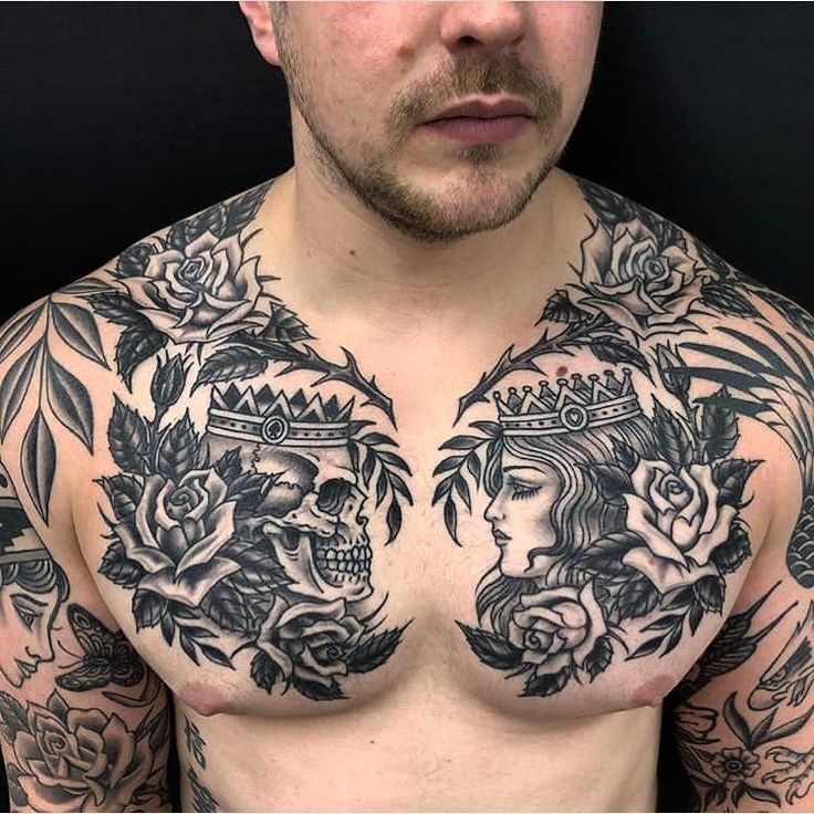 a man with tattoos on his chest and chest is looking at the camera while wearing a crown