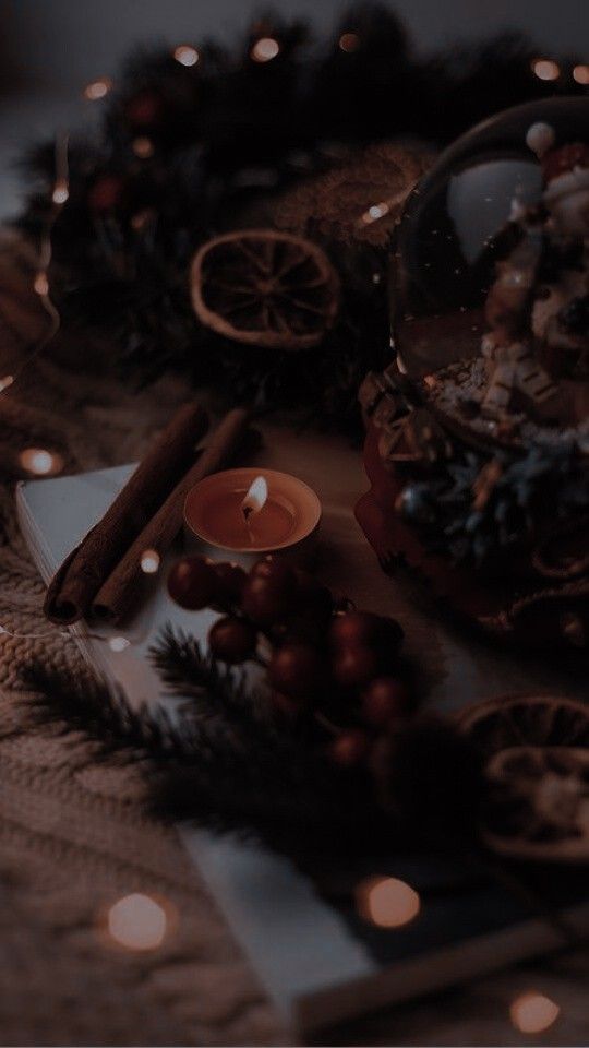 a table topped with candles and christmas decorations