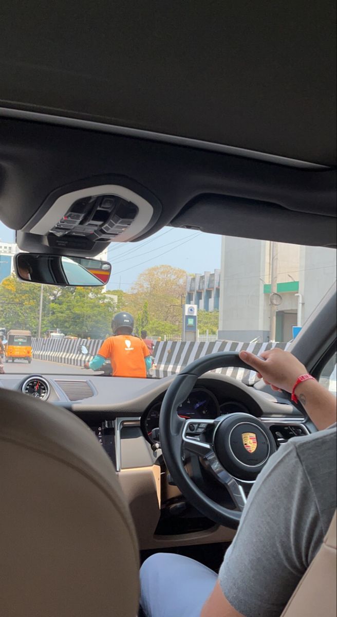 a woman driving a car on a city street