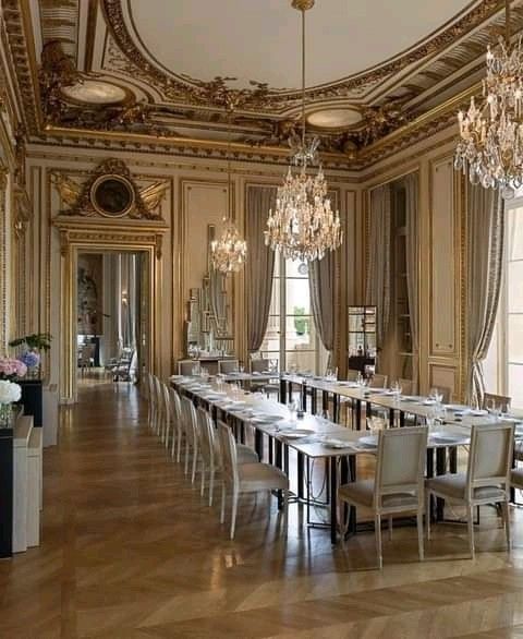 an elegant dining room with chandeliers and tables