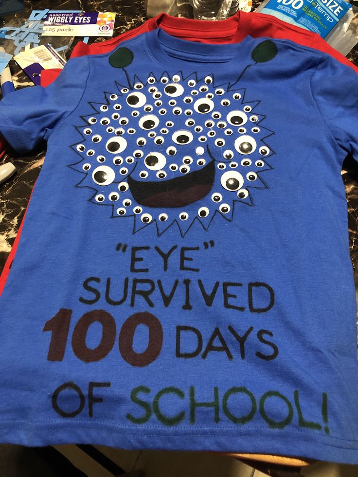 a blue t - shirt with eyeballs on it that says eye survived 100 days of school