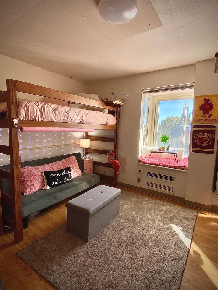 a bunk bed sitting next to a window in a bedroom