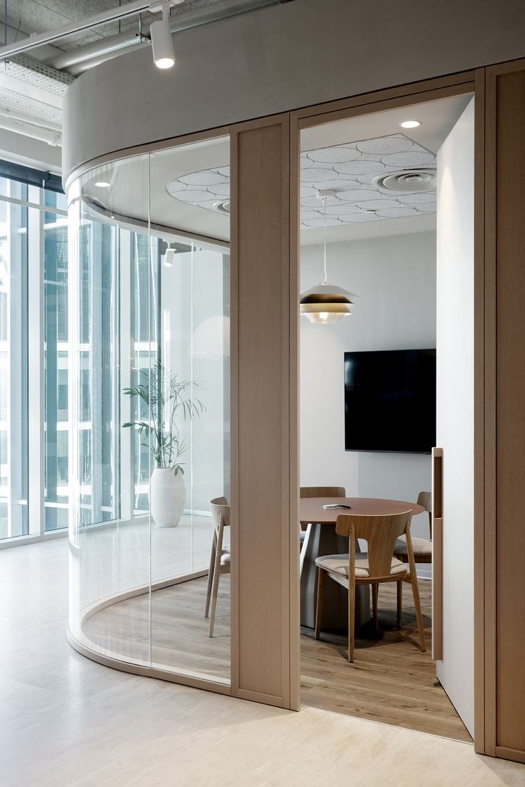 an office meeting room with large glass walls