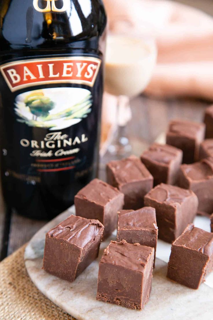 chocolate pieces on a plate next to a bottle of bailey's