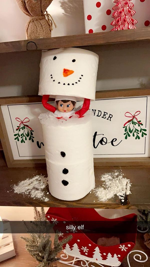 a toilet paper roll snowman sitting on top of a shelf