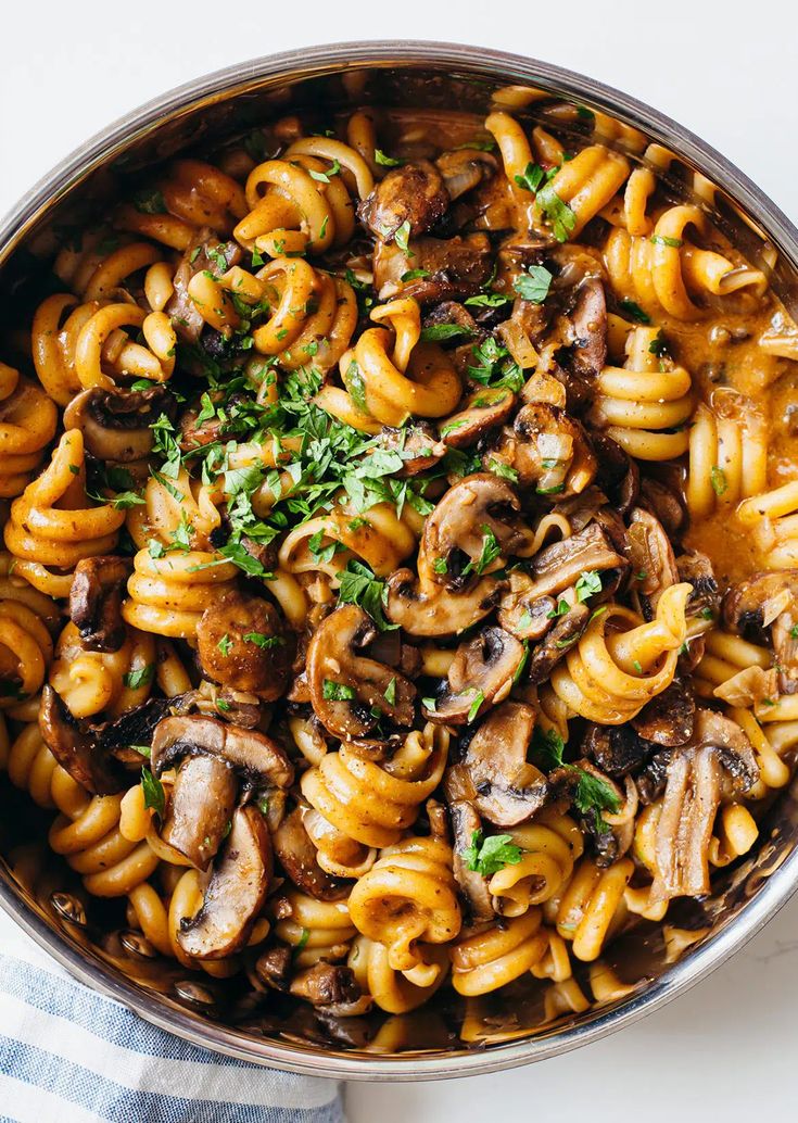 pasta with mushrooms and parsley in a pan