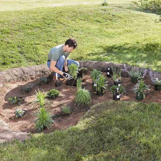 a man is working in the garden with plants