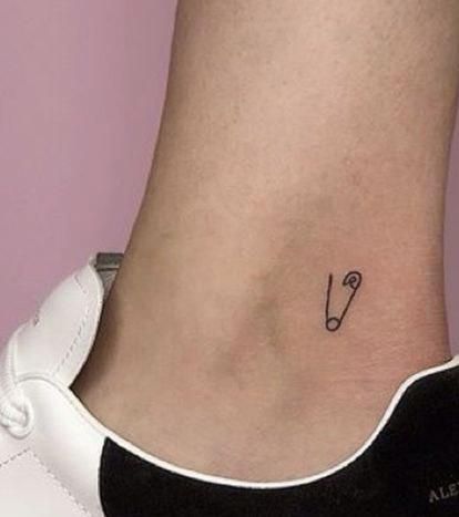 a small tattoo on the ankle of a woman