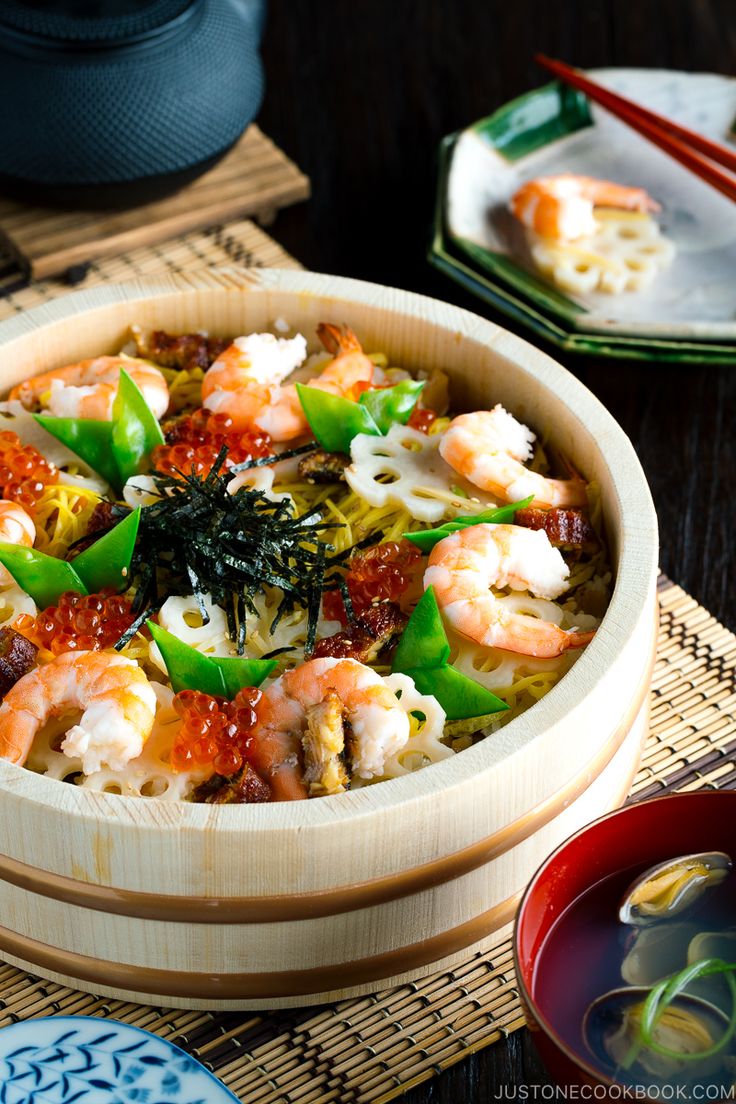 a wooden bowl filled with shrimp and veggies