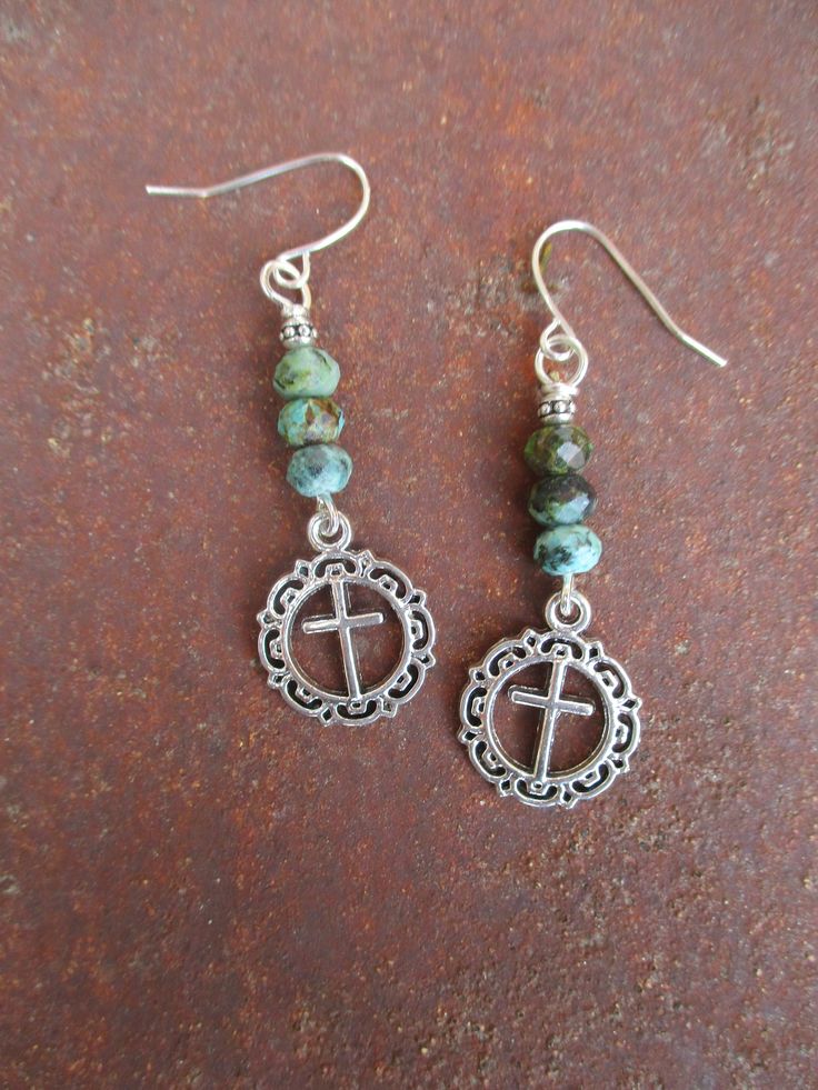 ♥Jewelry designs made by hand with heART♥ These earrings feature silver tone cross charms dangling from faceted round African turquoise and silver finish accent beads. They measure  2 inches from the top of the pierced ear wires. The earrings pictured are the ones you will receive. Handmade, Ready to ship. Ready to give away or to treat yourself! Enjoy ♥ Bohemian Sterling Silver Cross Jewelry, Adjustable Turquoise Cross Jewelry, Nickel Free Adjustable Cross Earrings, Handmade Turquoise Cross Jewelry, Handmade Green Cross Jewelry, Nickel-free Cross Earrings As Gift, Nickel-free Cross Earrings For Gift, Nickel Free Sterling Silver Cross Earrings, Nickel-free Sterling Silver Cross Earrings