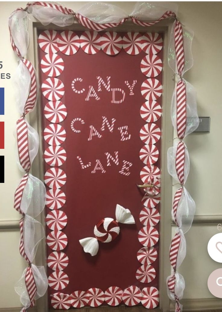 the door is decorated with red and white candy canes, ribbons, and letters