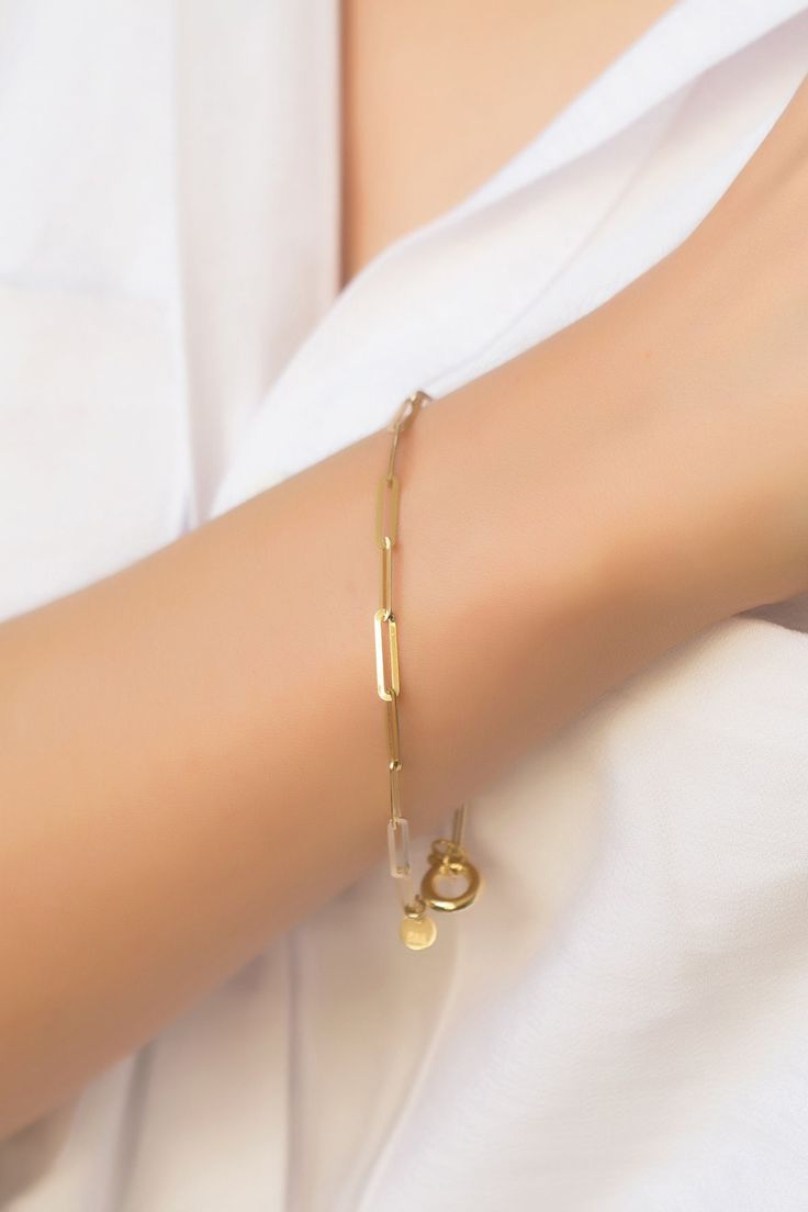 "Paperclip Chain 14k Solid Gold Bracelet, Rectangle Long Link Bracelet, Oval Link Chain Bracelet, Stylish Bracelet, Anniversary Gift its presence will make a difference on your wrist with its special design. It is suitable for daily use as well as for special occasions. More details; Our product is 2.85 gr in weight and 17 cm in length. Your products will be shipped with free shipping UPS express within 1-3 business days. All of our products has the stamp \"585\" on them. (which states that this Luxury Box Chain Bracelets For Anniversary, Gold Bracelet With Rectangular Cable Chain Links, Modern Gold Bracelet With Oval Link, Modern Gold Cable Chain Bracelets, Modern Gold Cable Chain Bracelet, Gold Oval Link Modern Charm Bracelet, Gold Plated Oval Link Paperclip Bracelet Gift, Gold-tone Cable Chain Bracelets For Gifts, Modern Gold-tone Bracelets With Paperclip Chain