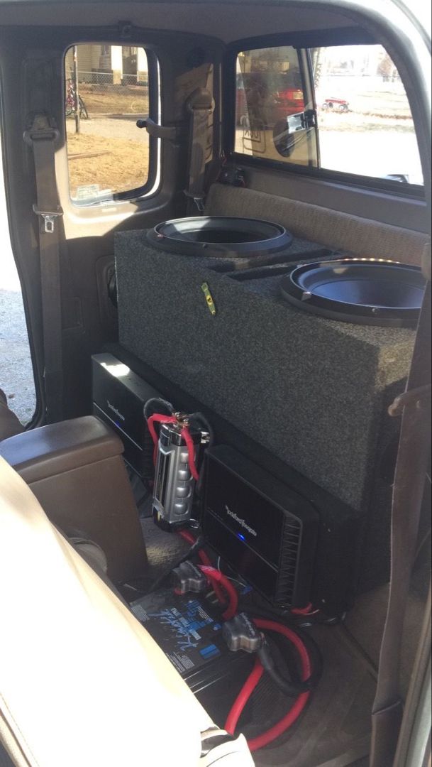 the back end of a vehicle with speakers and other equipment in it's trunk