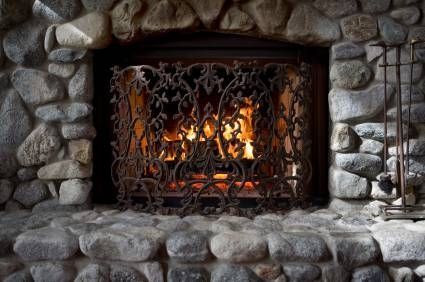 a stone fireplace with a fire in it