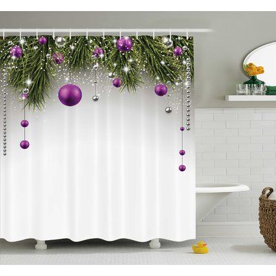 a shower curtain with christmas decorations hanging from it's side and purple balls on the top