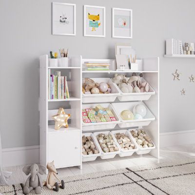 a white book shelf filled with books and toys