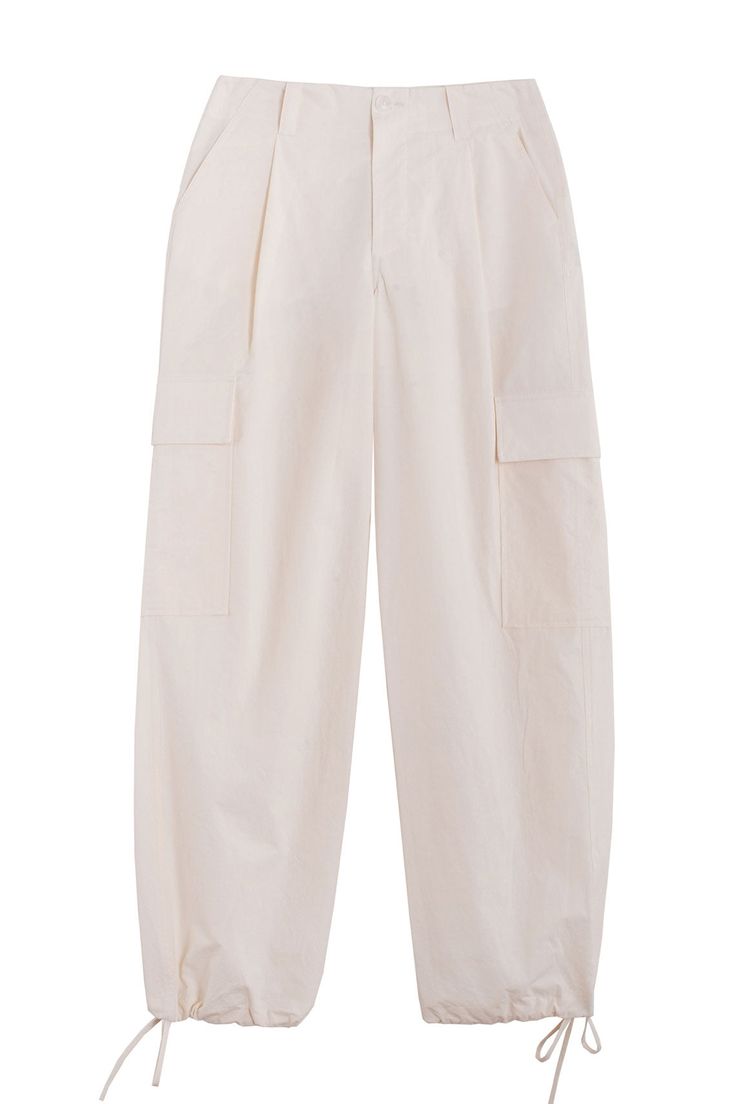 Loosely tailored cargo pant in a soft yet structured cotton. Straight leg with tie at ankle, cinch for a more tapered silhouette. Side pockets and oversized patch pockets above knee. Made in New York City. Fabric is 100% cotton. Ella is 6' tall, 35" bust, 26" waist, 36" hip, and is wearing a size S. Workwear Wide-leg Cargo Jeans With Side Pockets, Cotton High-waisted Pants With Flap Pockets, Baggy Cargo Jeans For Work, Baggy Cargo Jeans With Side Pockets For Workwear, High-waisted Relaxed Fit Cargo Pants With Patch Pockets, Beige Cargo Jeans With Pockets For Work, Beige Cargo Pants With Multiple Pockets For Work, High-waisted Cotton Cargo Jeans For Work, Beige Ankle-length Cargo Pants For Work