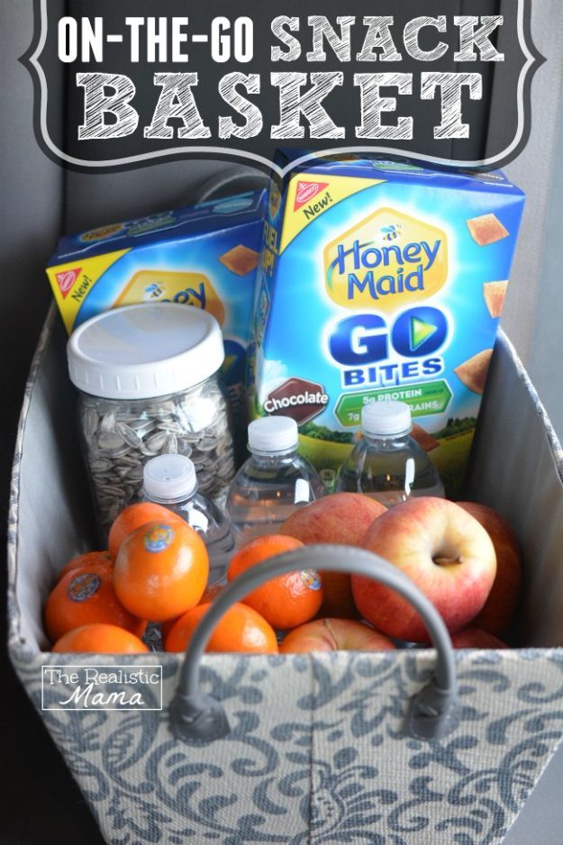 a basket filled with fruit and snacks sitting on top of a table