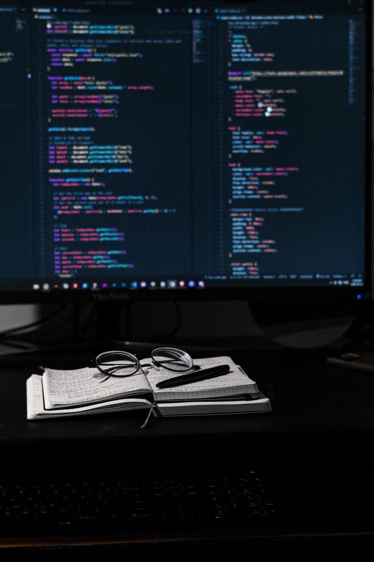 a computer monitor sitting on top of a desk next to a keyboard and mouse,