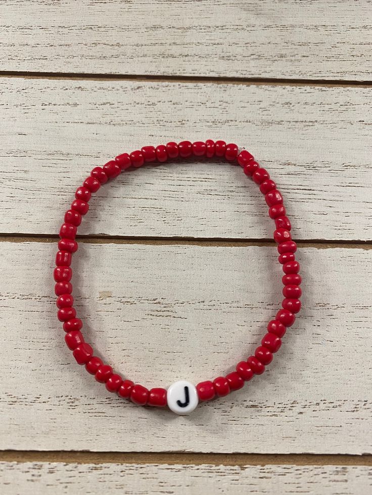 Red Initial Bracelet  Handmade with beads and so much love  Approximately 7 inches each in size. You can message us if you prefer a different size for your bracelet/bracelets  You choose which initial you want! You could choose your initial or the person you love initial Diy Weaving, 15th Birthday, Initial Bracelet, Bracelet Handmade, So Much Love, Vanity Set, You Choose, Handmade Bracelets, Want You