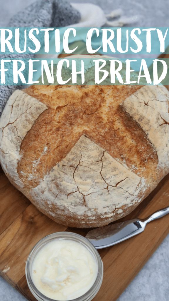 a loaf of bread sitting on top of a cutting board next to a bowl of cream