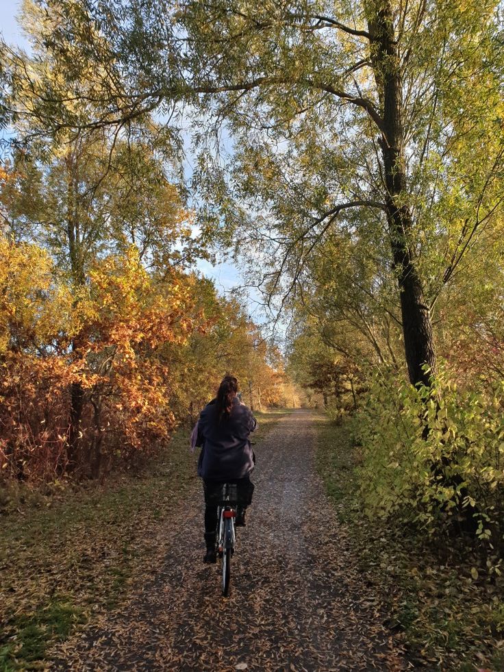 a person riding a bike down a dirt road