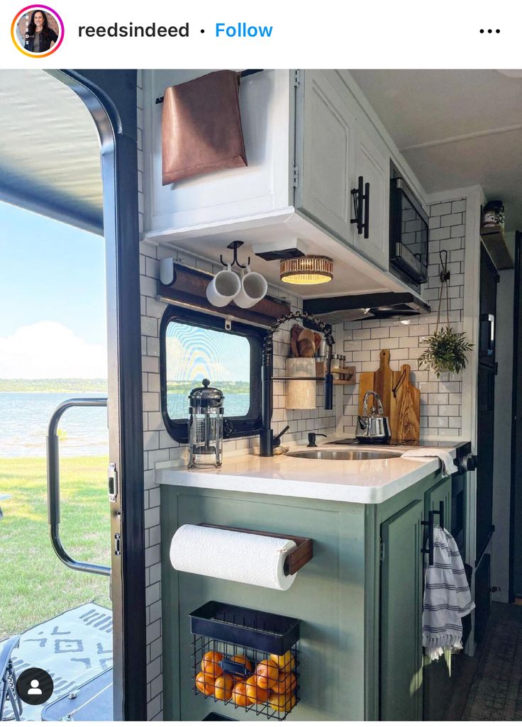 an rv kitchen with white cabinets and green counter tops is featured in the instagram