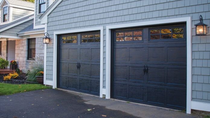 two garage doors are open in front of a house