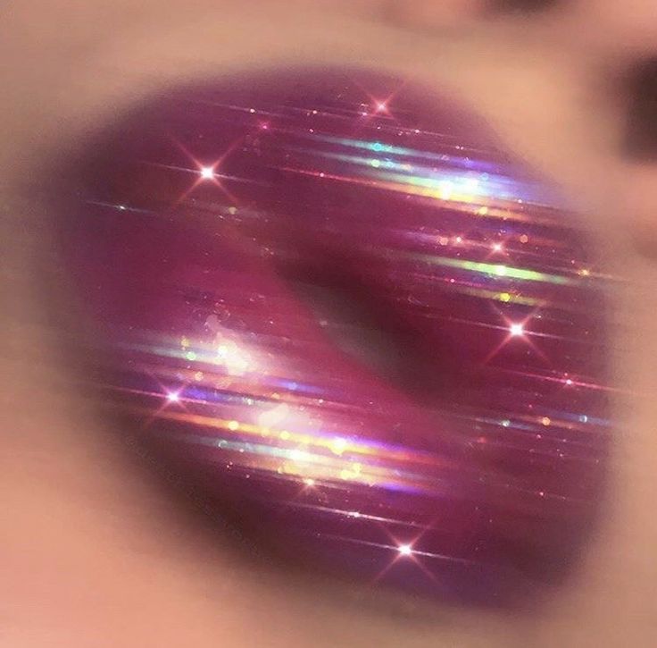 a person's eye looking through the iris of a purple object with stars on it